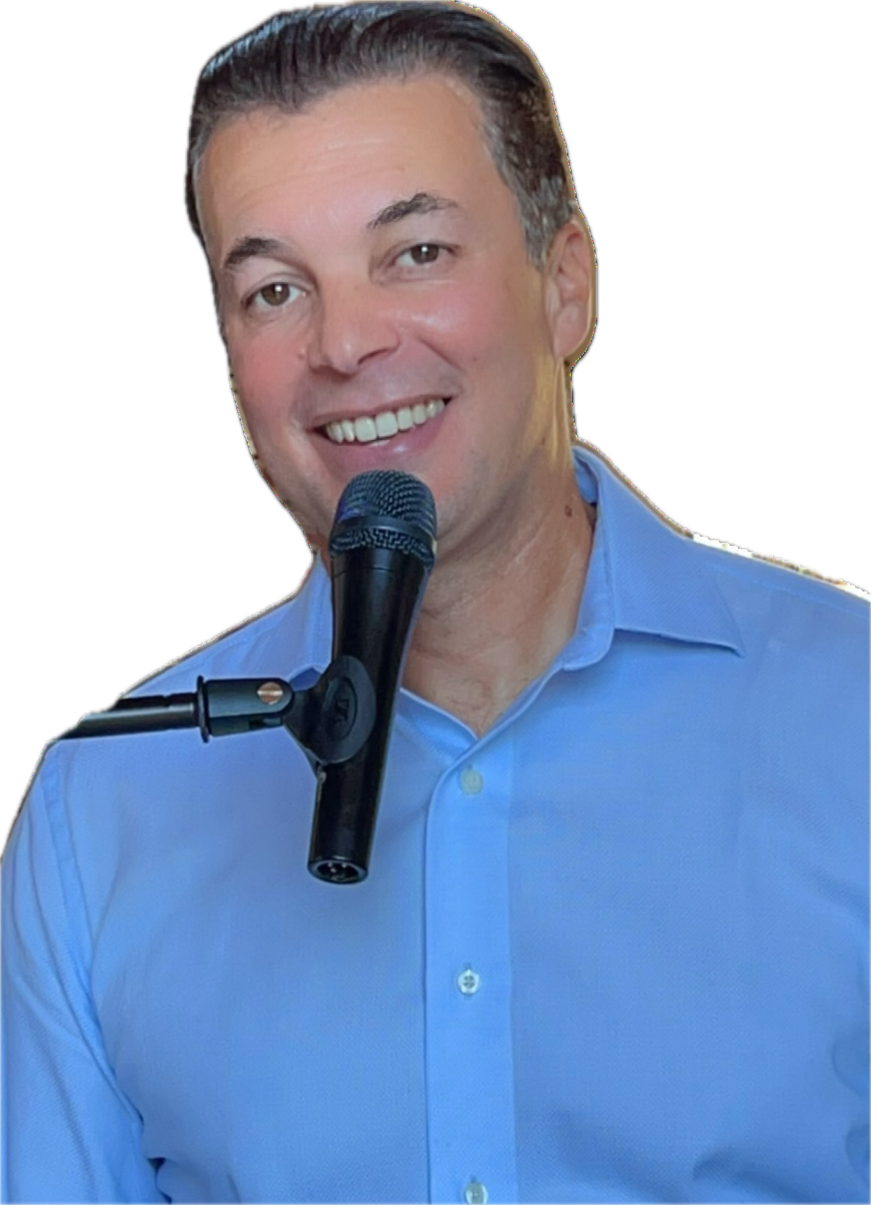Sami Ihsane smiling at the microphone in a blue shirt